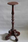 An unusual possibly Dutch Colonial carved hardwood torchere, with turned column and quadruped