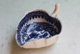 An early blue and white leaf moulded sauce boat, decorated with the lone fisherman pattern, probably