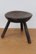 A 19th century rustic elm milking stool, retaining traces of original paint