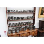 A large group of 18th/19th Century pewter measures and jugs, etc