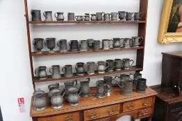 A large group of 18th/19th Century pewter measures and jugs, etc