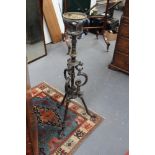 A Victorian cast iron oil lamp stand, on shaped tri-form supports