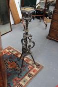 A Victorian cast iron oil lamp stand, on shaped tri-form supports