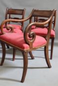 A set of eight late Georgian mahogany dining chairs, with carved back panels and overstuffed