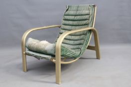 A mid Century alloy framed armchair, with upholstery hammock seat