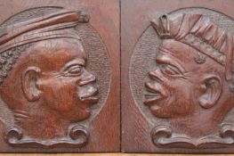 Two antique carved oak panels, each with a relief profile portrait of a Blackamoor, height 20cm