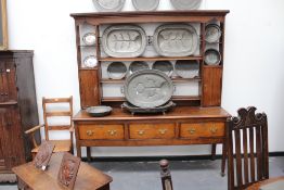 A Georgian and later inlaid oak countrymade highback dresser, the open rack with flanking cupboards,
