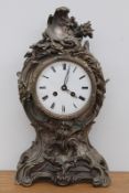 A French silvered bronze Rococo style mantel clock, the elaborate scroll and foliate case with