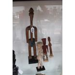 Four carved tribal stylized standing figures, retaining some polychrome decoration, possibly