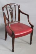 A Georgian mahogany open armchair, with carved pierced decorated back, on square fluted fore legs