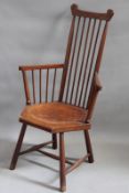 A 19th Century Arts and Crafts style spindle back armchair in the manner of Liberty & Co