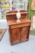 A William IV mahogany chiffonier, the raised shelf with turned supports above frieze drawer and