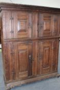 A large Continental 18th Century oak hall cupboard, with four moulded panel doors, 130cm wide