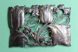 Archibald Knox For Liberty & Co: a silver buckle in the form of entwined tulips, London 1899, approx