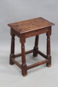 An 18th Century oak joint stool, the moulded edge top over moulded stretchers, on turned legs,
