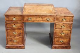 A Victorian yew wood pedestal "Dickens"desk, the rising writing surface over three drawers to top