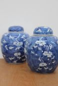 Two similar Chinese blue and white prunus decorated covered ginger jars, 26cm high