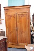 A 19th Century fruitwood armoire with panel doors, two fitted interior drawers and shaped apron,