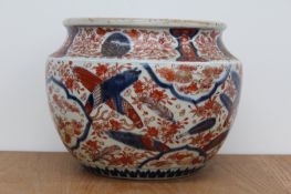 An antique Japanese Imari jardiniere, with panels of shells surrounded by floral sprays, 22cms high