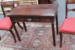 A George III mahogany tea table with fold over top on square chamfered legs, 91cm wide