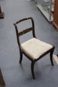 A set of six Regency faux rosewood and parcel gilt dining chairs, each with rope twist rail,
