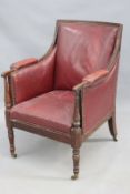 A Regency mahogany library armchair with close nailed red leather upholstery
