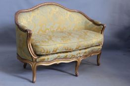 A French Louis XV style gilt show frame salon settee with gold damask upholstery, 130cm wide