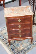 An ormolu mounted Louis IV style small four drawer commode, with shaped marble top