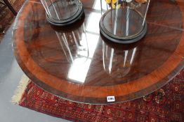 An inlaid Regency and later rosewood tilt top centre table, the crossbanded circular top on sabre