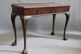 An antique early Georgian style mahogany serving table, standing on carved long cabriole legs with