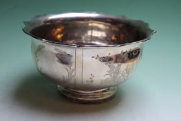 A Chinese silver coloured bowl decorated with panels depicting figures in landscape, 19cm diameter x