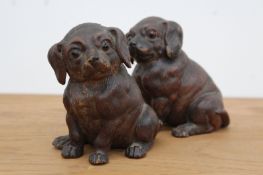 A pair of Continental pottery figures of pug dog puppies with glass eyes