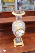 An unusual mantel clock of vase form, the hobnail cut crystal gilt bronze mounted body centred