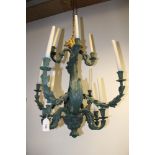 A pair of Rococo style verdigris twelve light chandeliers, with foliate scroll arms, 80cm high