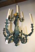 A pair of Rococo style verdigris twelve light chandeliers, with foliate scroll arms, 80cm high
