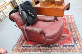 A 19th/20th Century deep seat Howard style armchair, with leather upholstery monogram WB on rear