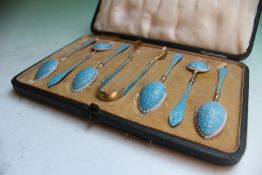 A cased set of six Norwegian silver and turquoise blue enamelled tea spoons and tongs, in a