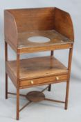 A Regency oak and inlaid gallery back washstand, the second tier with drawer, on X-frame stretcher