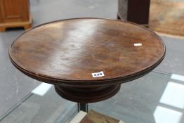 A large dish top mahogany lazy susan, on turned flared foot, 53cm diameter