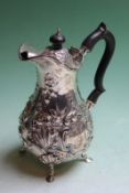 A silver pear shaped hot water pot, with repousse decorations, London 1902, Goldsmiths and