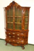 An antique Dutch carved and burl walnut display cabinet, with shaped cornice above multi pane glazed
