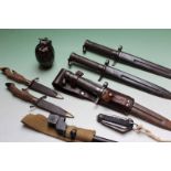 Two steel scabbard military bayonets, an Enfield stick bayonet, pocket knives and a dummy grenade
