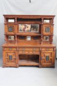 A large Victorian pollard oak mirror back sideboard, the moulded cornice above flanking panel door