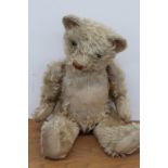 A large early 20th Century plush teddy bear.