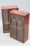 A pair of 19th Century mahogany wall cabinets, with glazed doors enclosing shelves, each 75 x 46cm