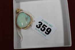 An 18ct gold mounted Australian 'Cooper Pedy' shell opal pendant