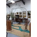 An old wrought iron and wirework rose archway, with scroll wire decoration, 304cm high x 170cm wide