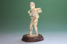 A Japanese sectional ivory figure of a peasant carrying a basket on his back, on plinth base, 20cm