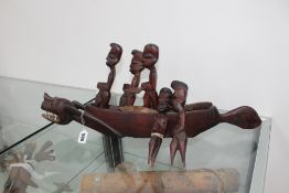 A carved "Dragon boat" with five paddlers, an African figural staff head, and two quivers or