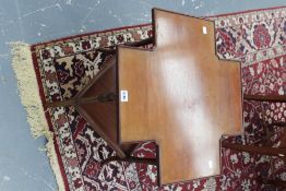 An interesting Edwardian mahogany occasional table, with cross shape top, slender ring turned legs